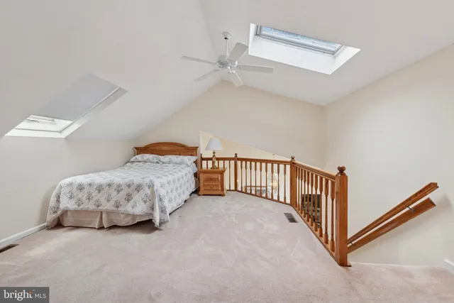 a bedroom with a bed and a lamp with wooden floor