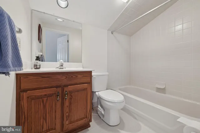 a bathroom with a sink toilet vanity and bathtub