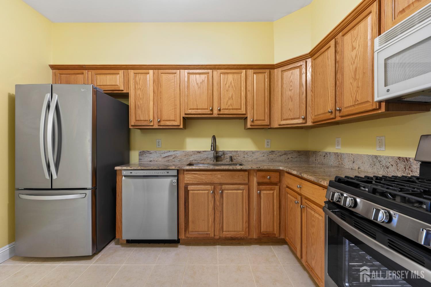 540 Cranbury Road East Brunswick, NJ 08816 - Photo 11 of 33 a kitchen with stainless steel appliances granite countertop a refrigerator and a stove