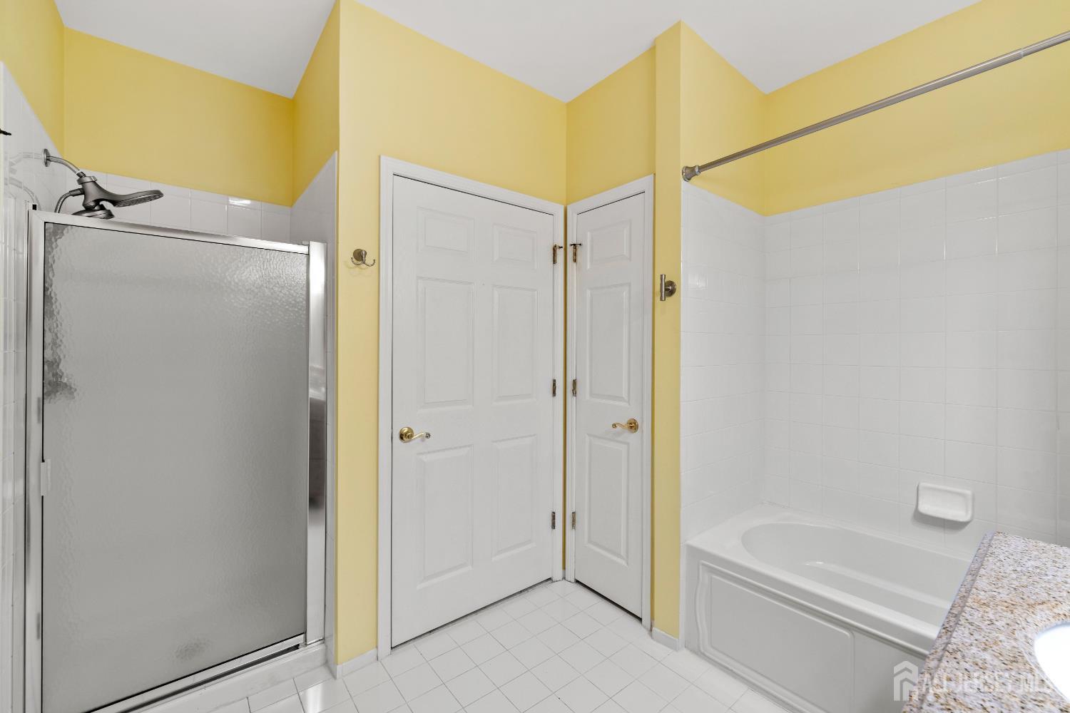 540 Cranbury Road East Brunswick, NJ 08816 - Photo 20 of 33 a bathroom with a bathtub and a shower