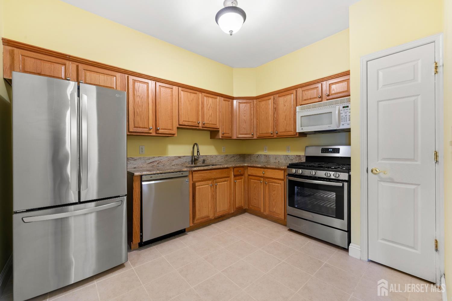540 Cranbury Road East Brunswick, NJ 08816 - Photo 10 of 33 a kitchen with stainless steel appliances granite countertop a refrigerator sink and stove