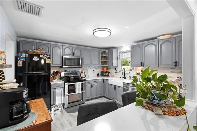 a kitchen with a sink stainless steel appliances and cabinets
