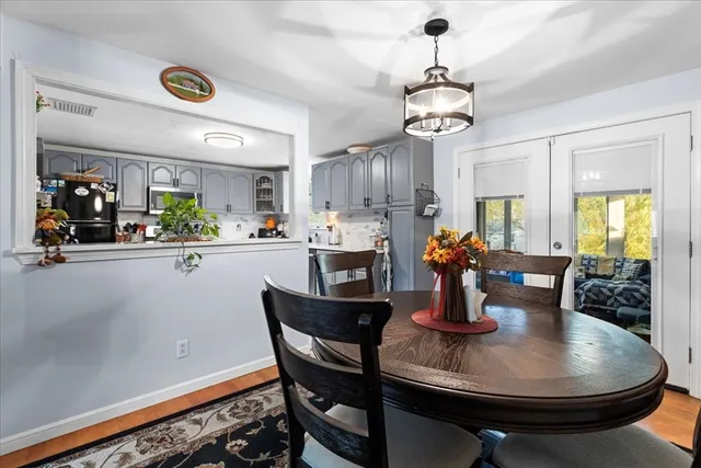 a dining room with furniture a chandelier and window