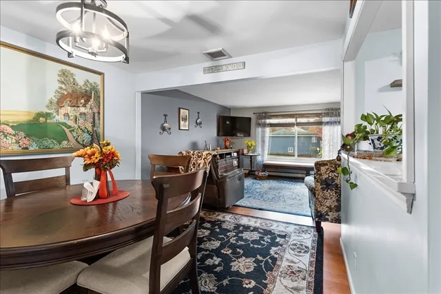 a view of a dining room with furniture window and wooden floor