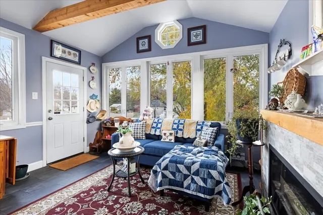 a living room with furniture and large windows