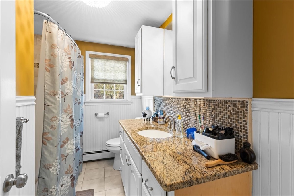 107 Ann Street Raynham, MA 02767 - Photo 16 of 34 a bath room with a granite countertop sink and a mirror