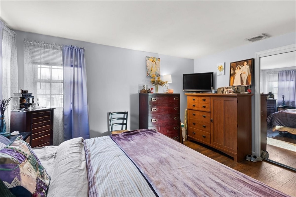 107 Ann Street Raynham, MA 02767 - Photo 17 of 34 a bedroom with a bed and wooden floor