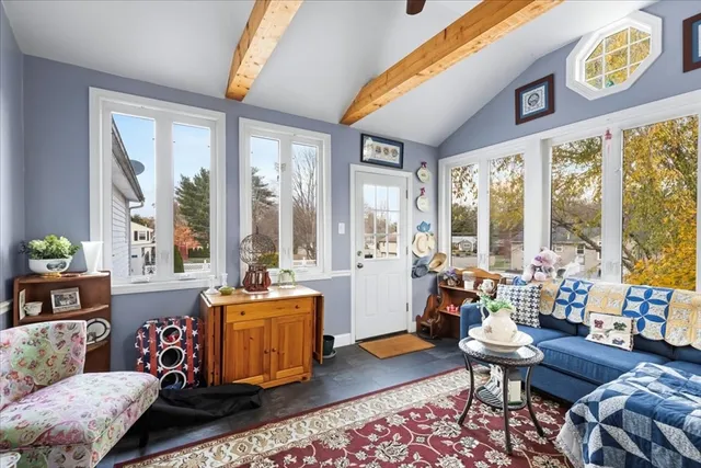a living room with furniture and floor to ceiling windows