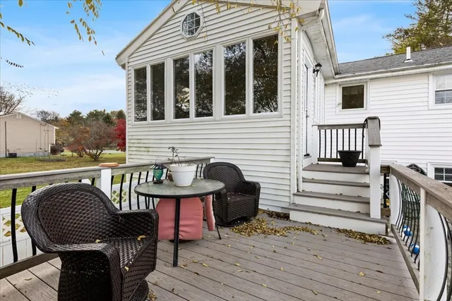 a view of a deck with wooden floor and outdoor seating