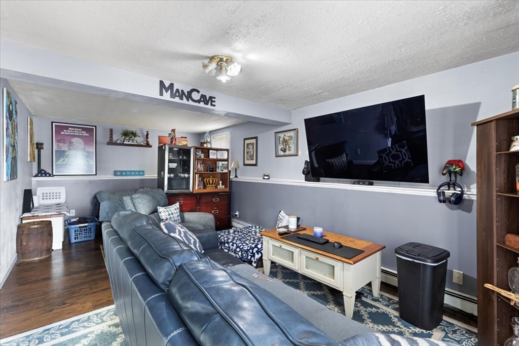107 Ann Street Raynham, MA 02767 - Photo 26 of 34 a living room with furniture and a flat screen tv