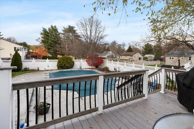 a view of a balcony with wooden floor and fence
