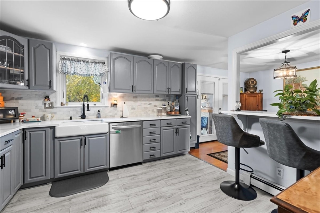 107 Ann Street Raynham, MA 02767 - Photo 7 of 34 a kitchen with sink cabinets and wooden floor