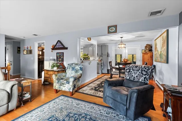 a living room with furniture rug and wooden floor