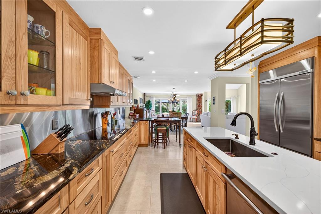 4030 Crayton Road, Unit C2 Naples, FL 34103 - Photo 8 of 32 a kitchen with stainless steel appliances granite countertop a sink a counter space cabinets and stainless steel appliances