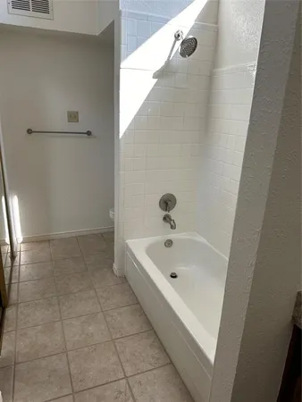 a bathroom with a tub and shower