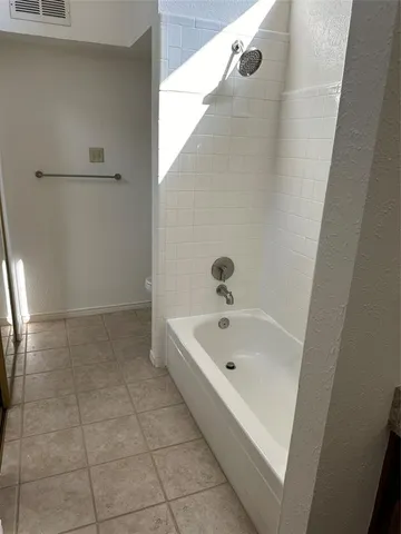a bathroom with a tub and shower