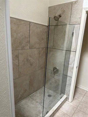 a bathroom with a glass door shower