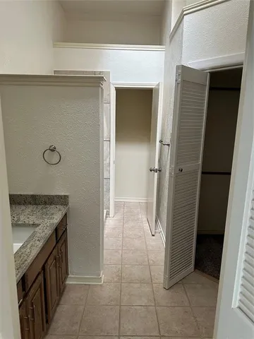 a view of a livingroom with wooden floor and a ceiling fan