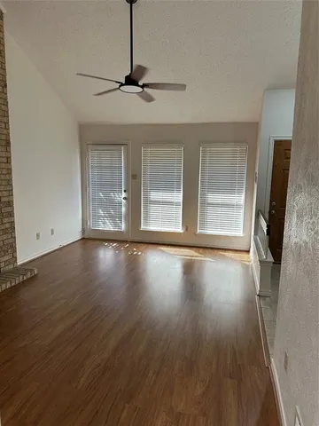 a view of kitchen with granite countertop stainless steel appliances a sink stove refrigerator and cabinets