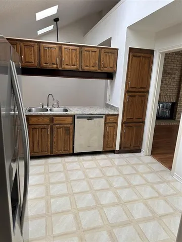 a kitchen with a stove top oven and cabinets
