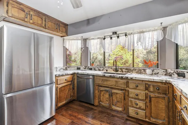a kitchen with stainless steel appliances granite countertop a stove and a refrigerator