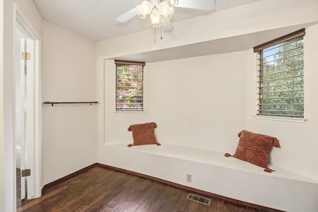 a room with a window and a ceiling fan