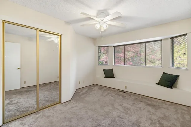 an empty room with windows and closet