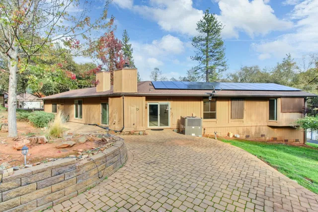 a front view of a house with a garden and yard