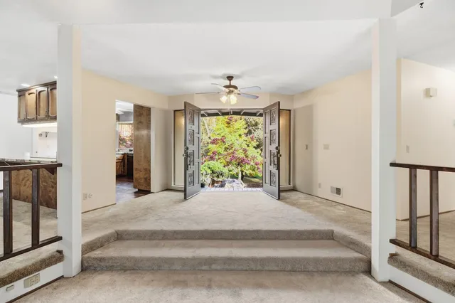 a bedroom with furniture and a large window