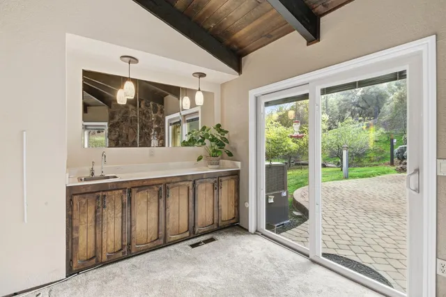 a view of a porch with furniture and floor to ceiling window