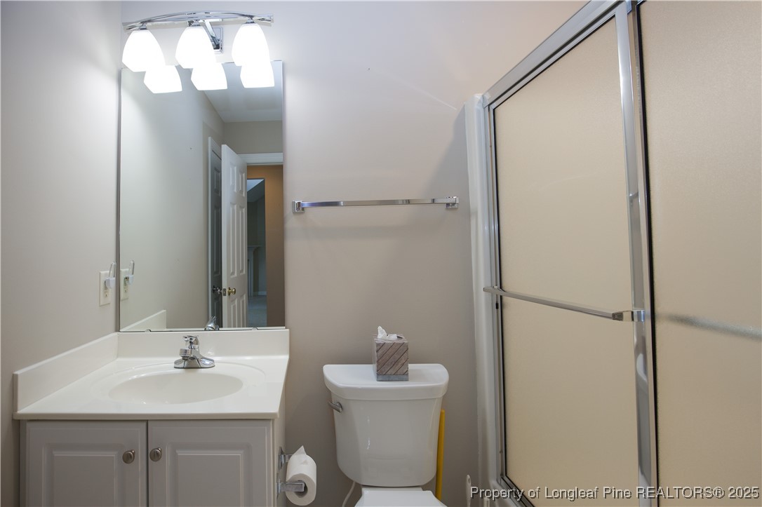 175 Knoll Road Southern Pines, NC 28387 - Photo 25 of 50 a bathroom with a sink and a mirror
