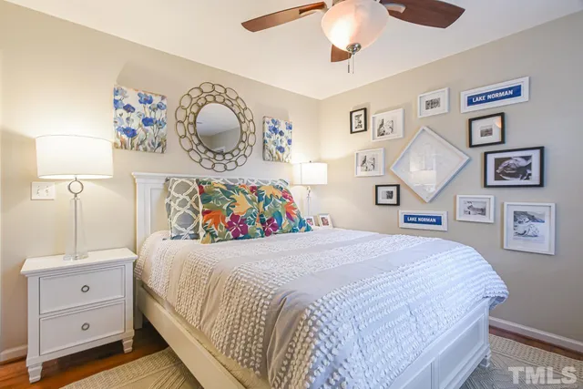 a bedroom with a large bed and a lamp