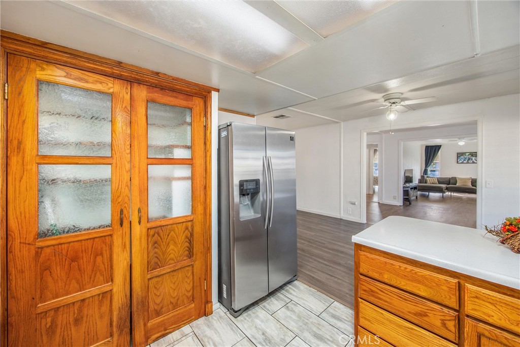 626 North Dearborn Street, Unit 56 Redlands, CA 92374 - Photo 12 of 30 a large kitchen with kitchen island granite countertop a refrigerator and a sink