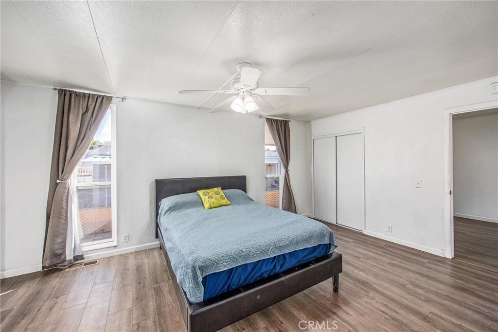 626 North Dearborn Street, Unit 56 Redlands, CA 92374 - Photo 16 of 30 a bedroom with a bed and a chandelier