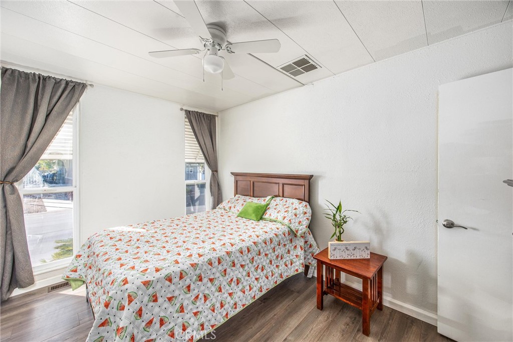 626 North Dearborn Street, Unit 56 Redlands, CA 92374 - Photo 21 of 30 a bedroom with a bed table and window