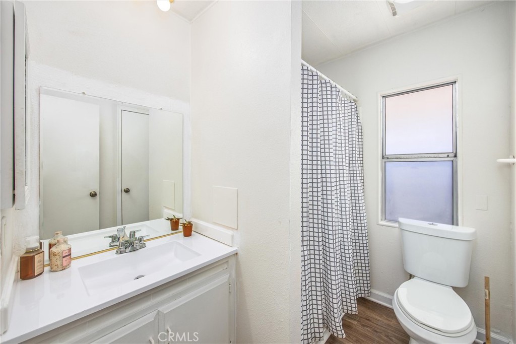 626 North Dearborn Street, Unit 56 Redlands, CA 92374 - Photo 23 of 30 a bathroom with a sink a toilet and shower