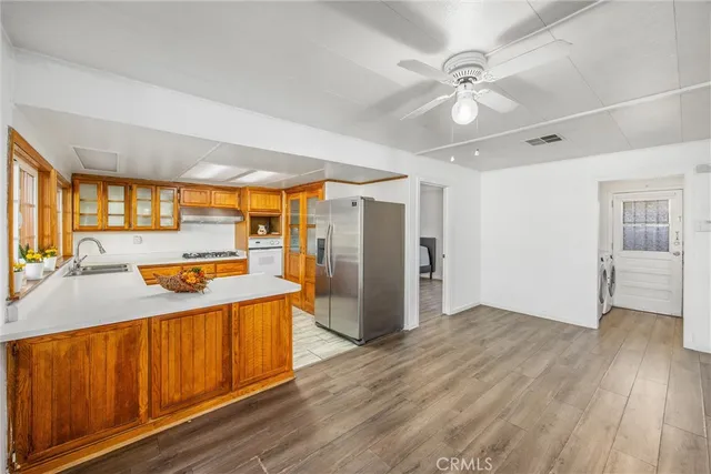 a view of a kitchen with a sink and a refrigerator