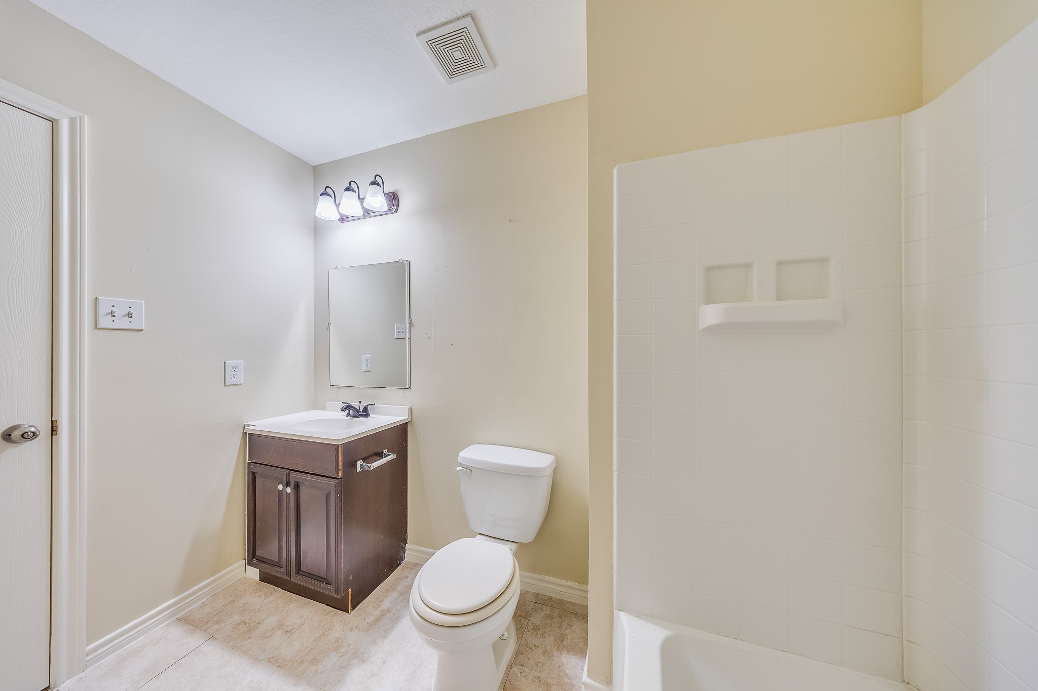 20003 Rustic Lake Lane Cypress, TX 77433 - Photo 17 of 21 a bathroom with a toilet a sink and mirror