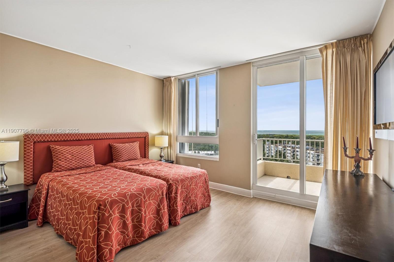 789 Crandon Boulevard, Unit 1005 Key Biscayne, FL 33149 - Photo 17 of 60 a bedroom with a large bed and a large window