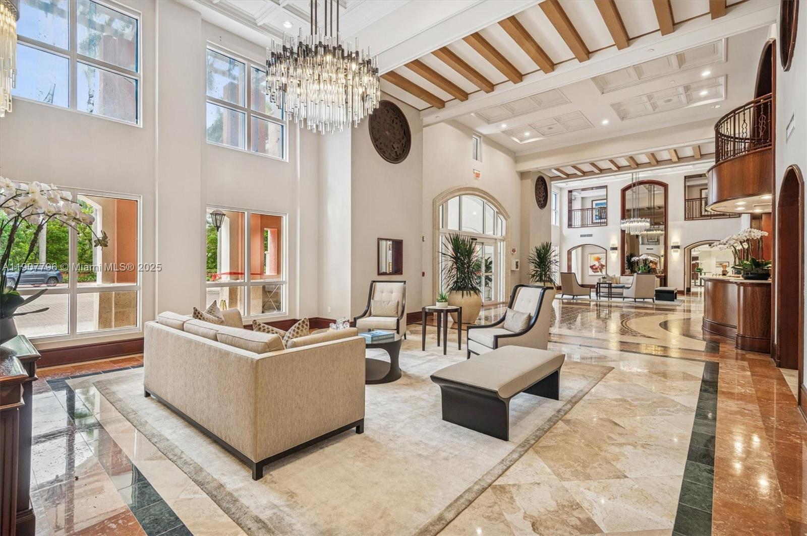 789 Crandon Boulevard, Unit 1005 Key Biscayne, FL 33149 - Photo 21 of 60 a living room with fireplace furniture and a chandelier