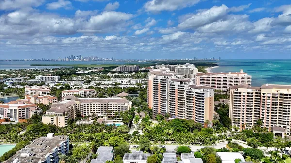 an aerial view of multi story residential apartment building with yard