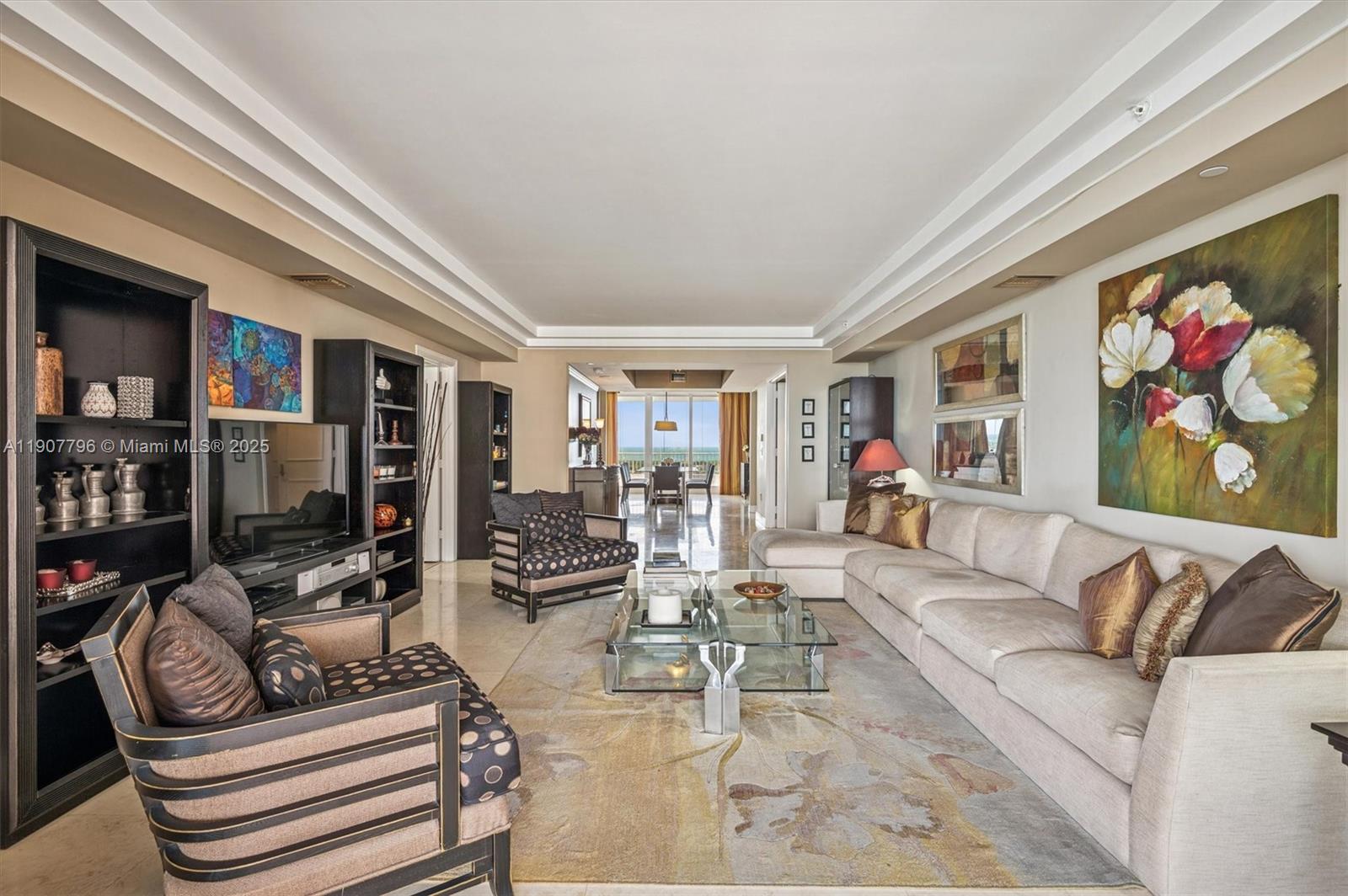 789 Crandon Boulevard, Unit 1005 Key Biscayne, FL 33149 - Photo 5 of 60 a living room with furniture and a floor to ceiling window