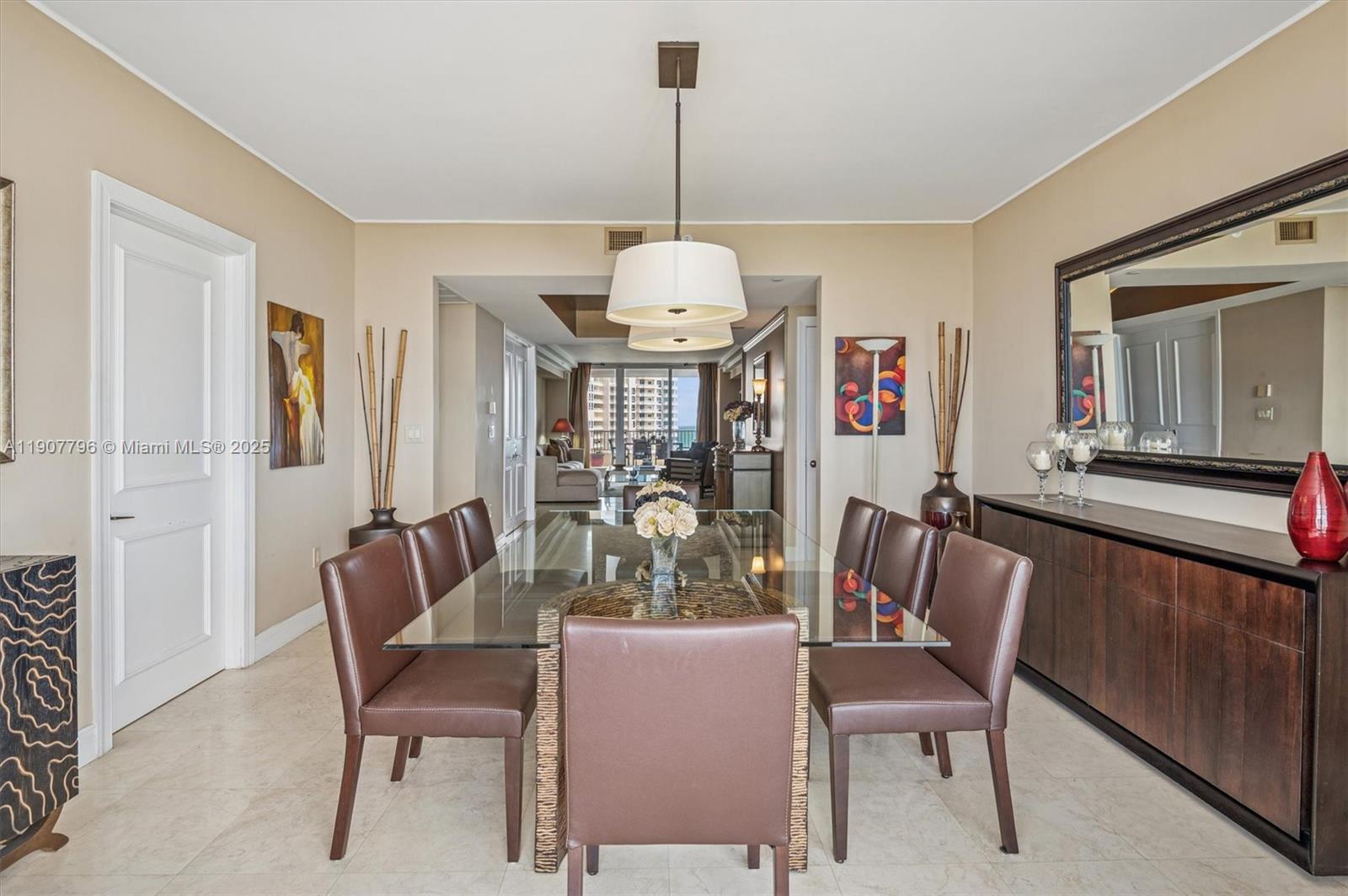789 Crandon Boulevard, Unit 1005 Key Biscayne, FL 33149 - Photo 7 of 60 a dining room with furniture a chandelier and window