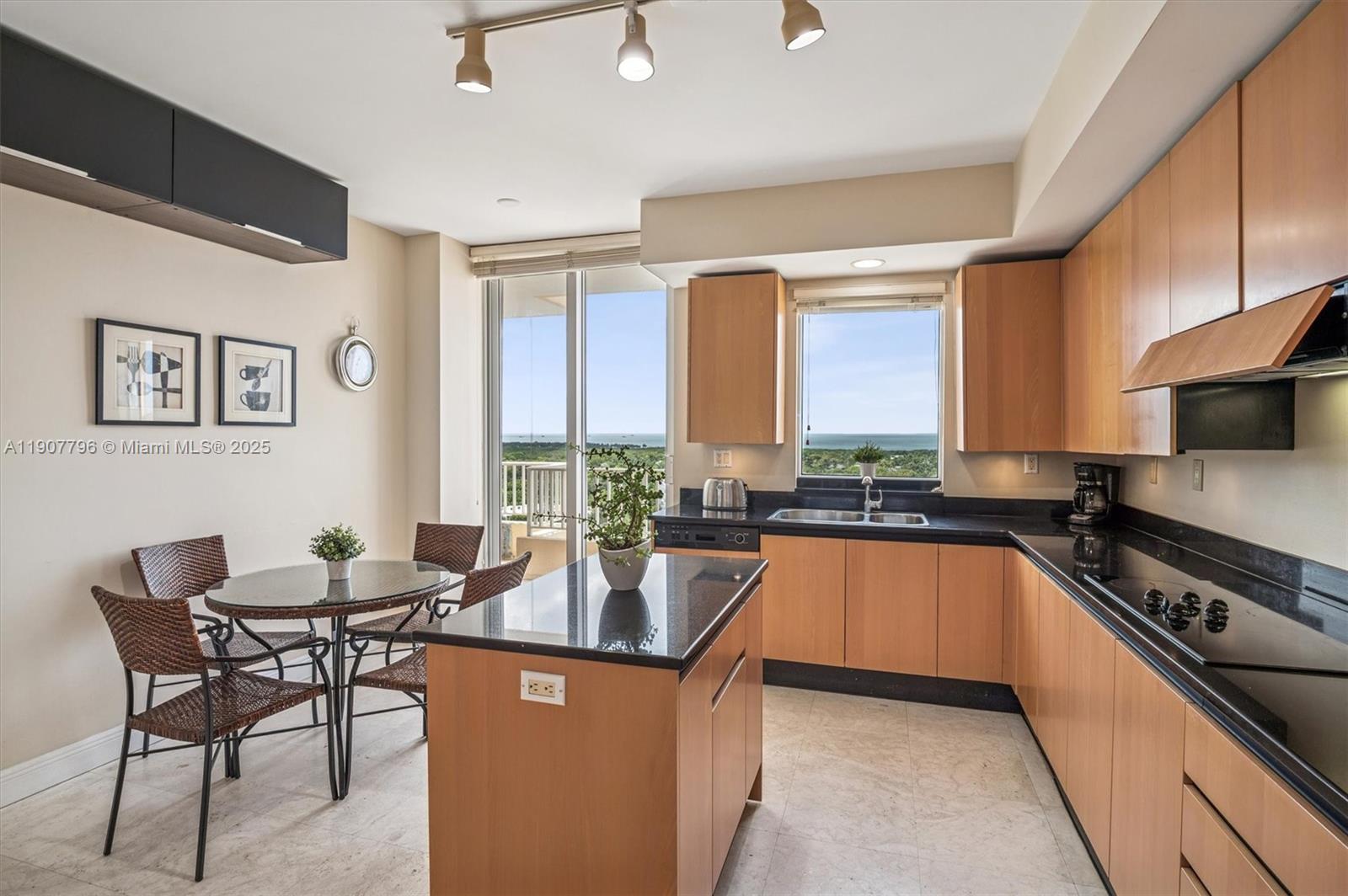 789 Crandon Boulevard, Unit 1005 Key Biscayne, FL 33149 - Photo 9 of 60 a kitchen with stainless steel appliances granite countertop a stove a sink and a refrigerator