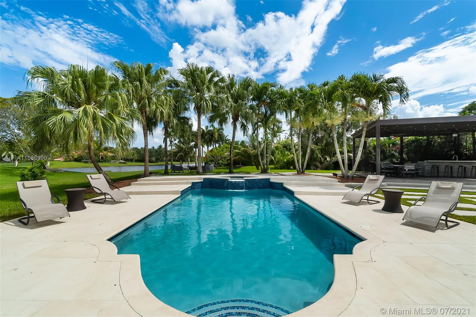 2850 Windmill Ranch Road Weston, FL 33331 - Photo 2 of 50 a view of a swimming pool with a patio