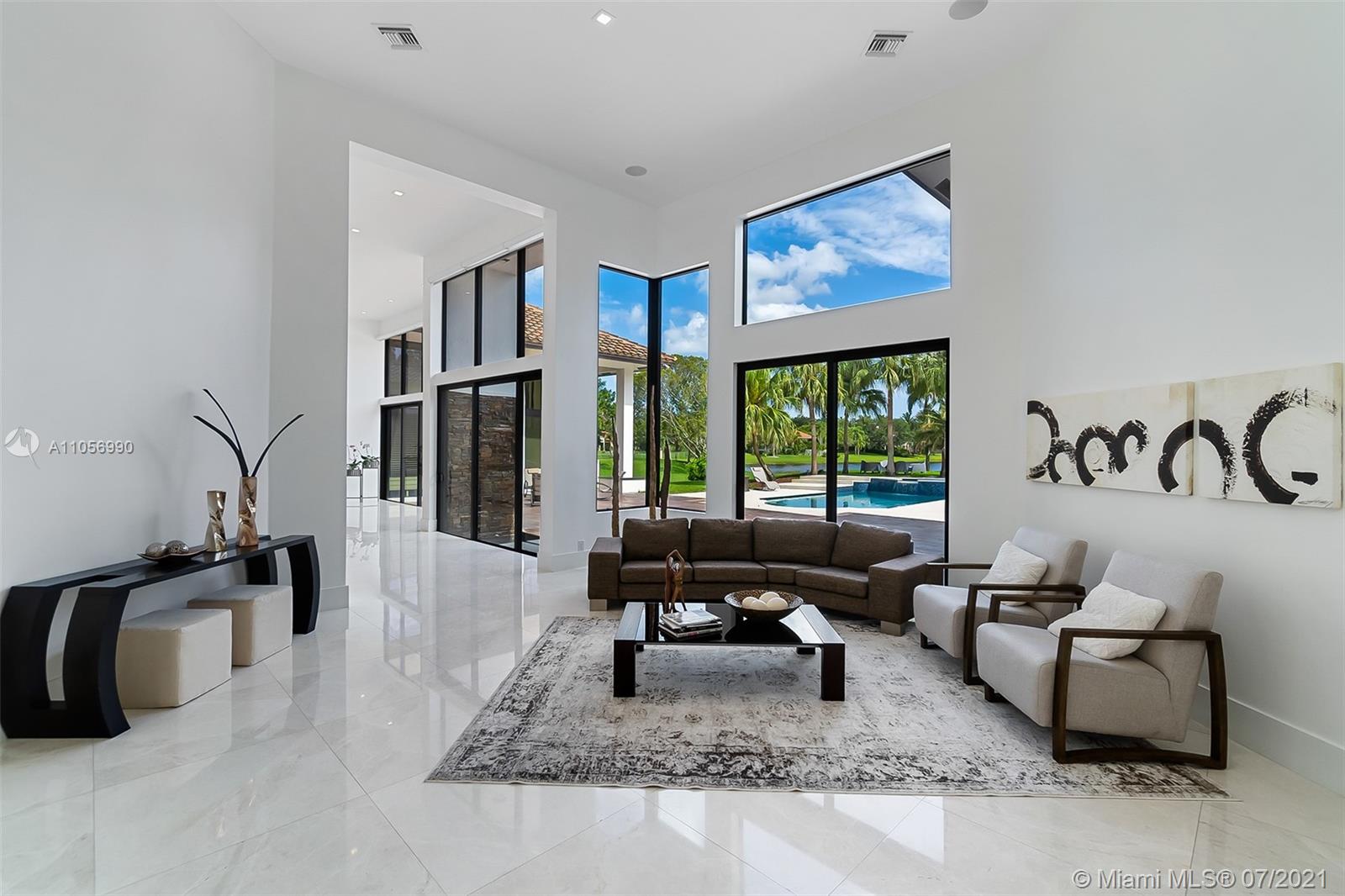 2850 Windmill Ranch Road Weston, FL 33331 - Photo 4 of 50 a living room with furniture large window and flat screen tv