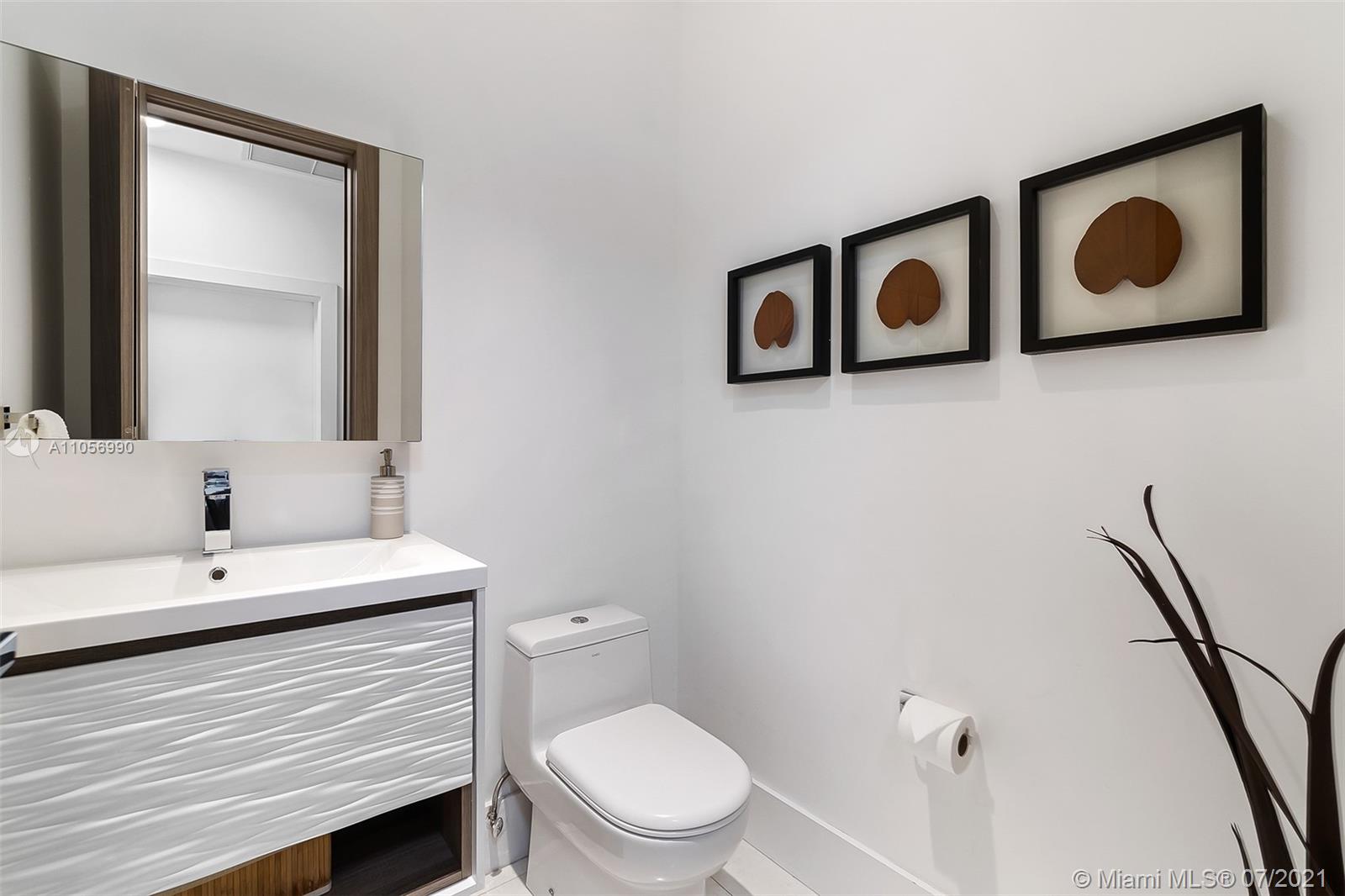 2850 Windmill Ranch Road Weston, FL 33331 - Photo 31 of 50 a bathroom with a toilet sink and mirror