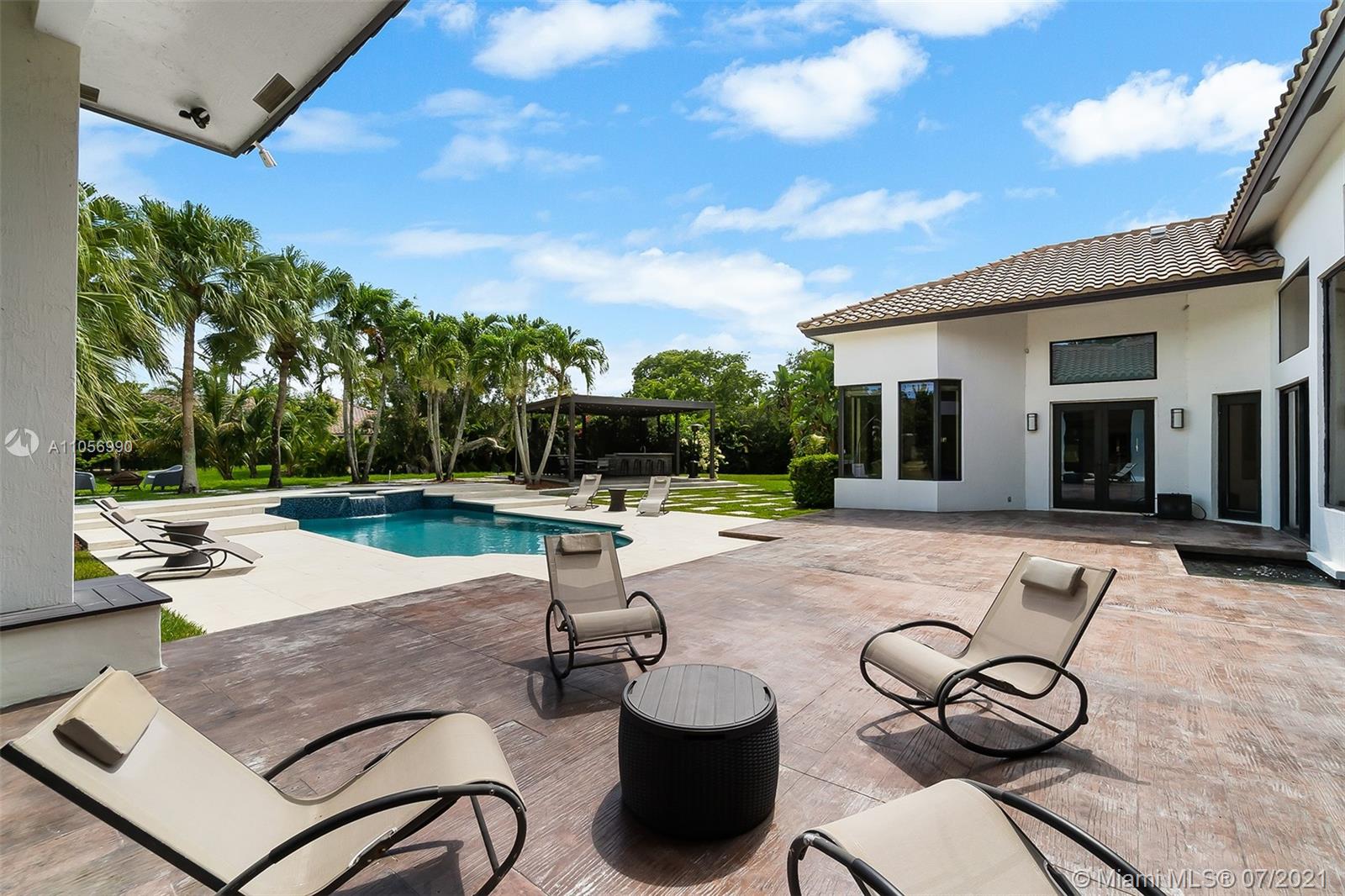2850 Windmill Ranch Road Weston, FL 33331 - Photo 35 of 50 a view of a patio with couches chairs and a fire pit