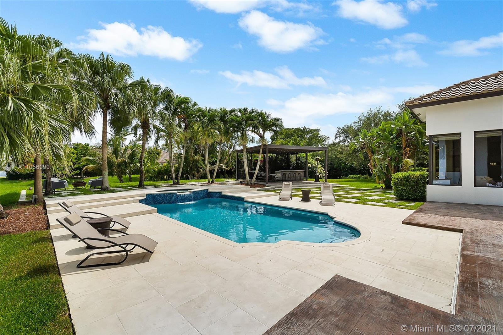 2850 Windmill Ranch Road Weston, FL 33331 - Photo 39 of 50 a view of a swimming pool with chairs