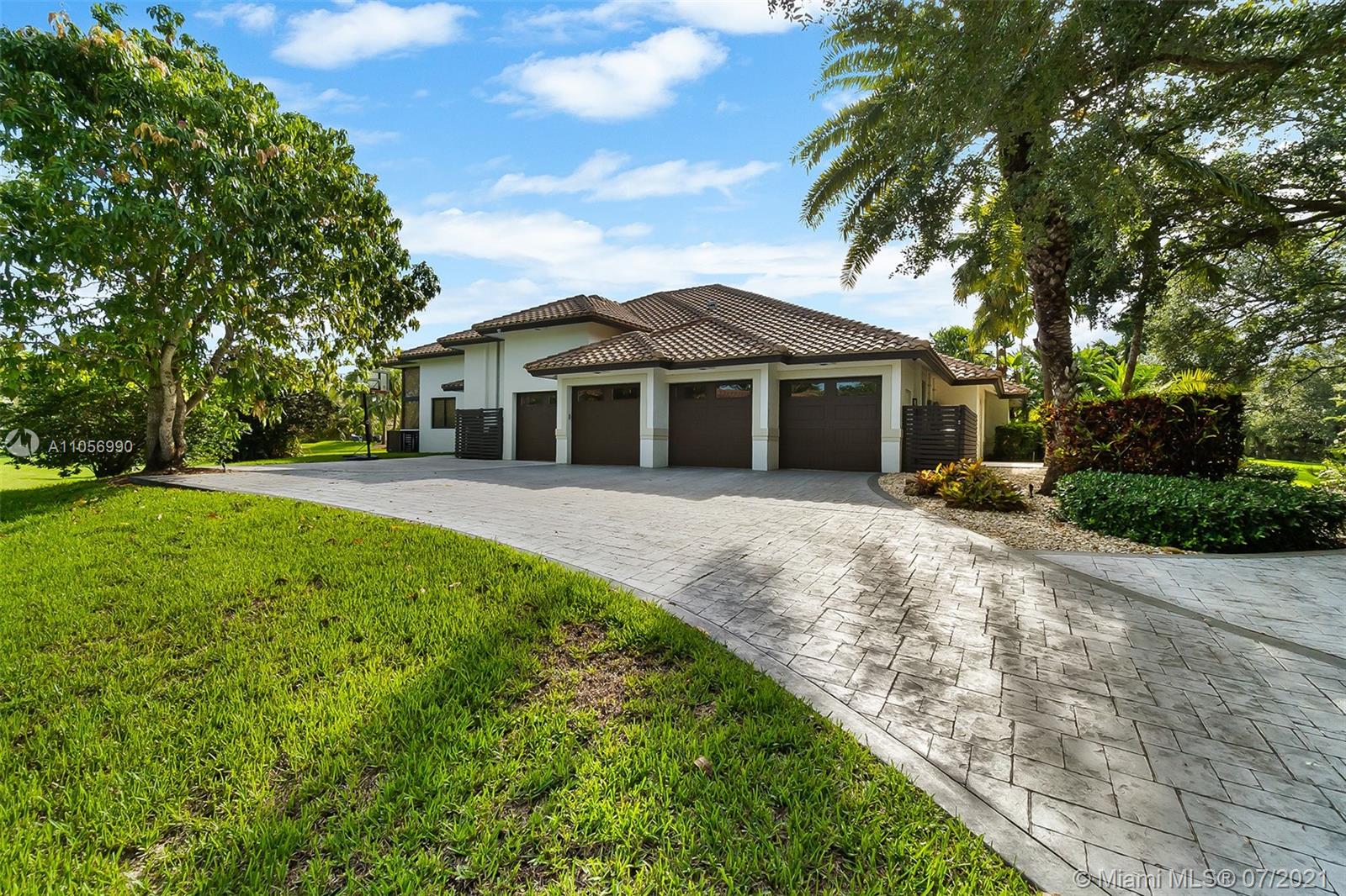 2850 Windmill Ranch Road Weston, FL 33331 - Photo 46 of 50 a front view of a house with yard and green space